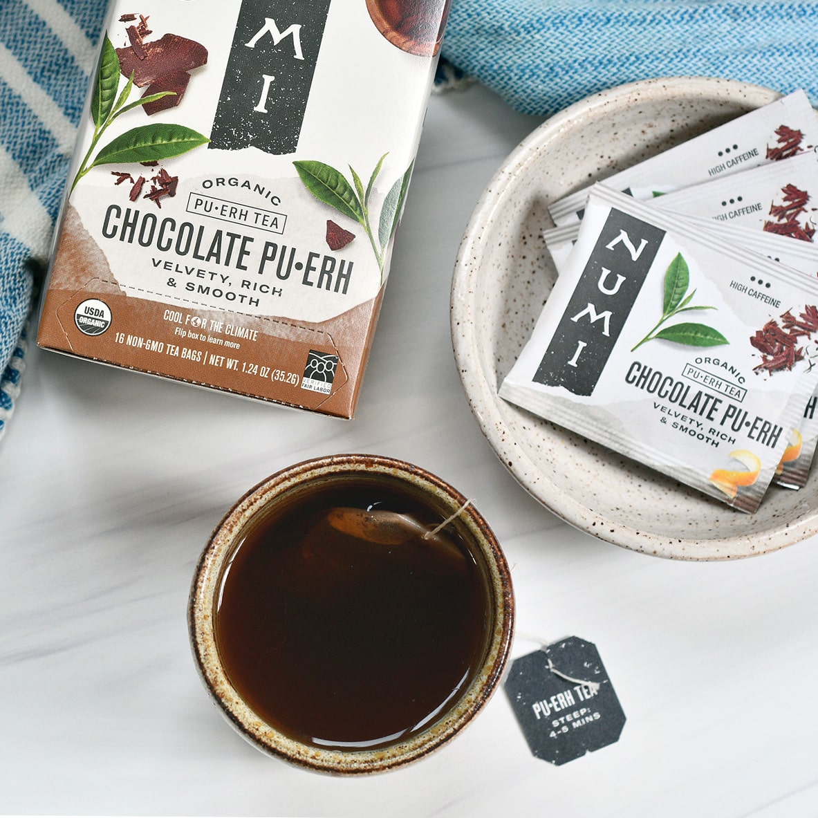 a hot cup of numi organic chocolate pu-erh tea & tea bags