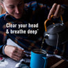 A woman is pouring her tea in a reusable cup