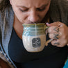 A woman enjoys a cup of Throat Soother, a part of the Numi Stay Healthy Teas